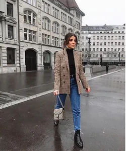 Chic brown houndstooth double-breasted blazer styled with jeans in an urban street setting