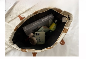 Interior view showing the large capacity and dark lining of the striped tote bag
