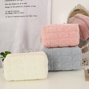 Quilted cloud texture plush makeup bags in pink, blue, and beige with zippers