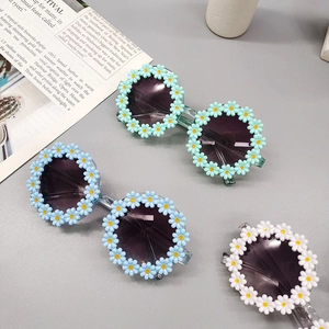 Detailed view of kids daisy flower sunglasses in mint green, sky blue and pearl white
