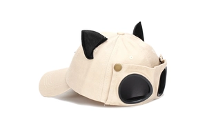 Detail of beige cotton baseball cap with cute black cat ears and pilot goggles on back