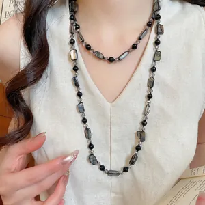 Bohemian double-layer beaded necklace featuring black agate and shell pendants