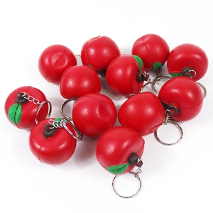 Flat lay of 12 cute mini red tomato keychain pendants made of soft PU foam material