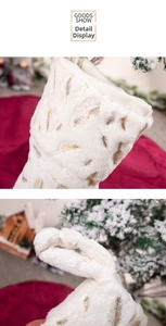 Detail of white plush Christmas stocking with gold feather embroidery and hanging loop
