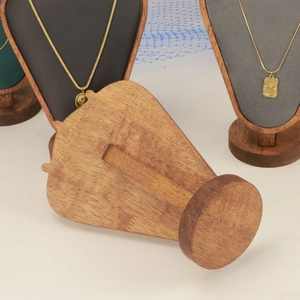 Detail of wooden necklace display stand featuring rich brown grain and sturdy back support