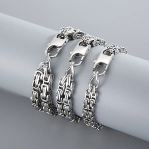 Macro view of Byzantine stainless steel chain bracelet with durable lobster clasp