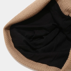 Close-up of khaki ribbed knit beanie with black lining showing double-layer texture