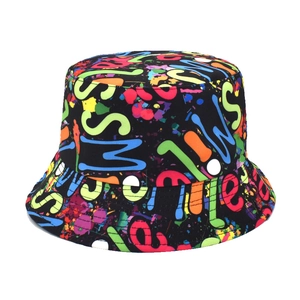 Detail of colorful graffiti print and Smile text on a black reversible bucket hat