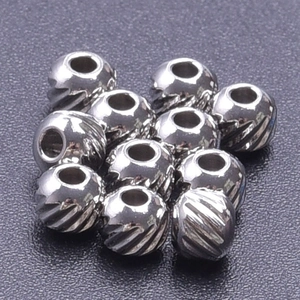 Macro shot of 11 striped 304 stainless steel beads for DIY jewelry making
