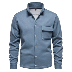 Detail of blue waffle knit jacket showing chest pocket with silver snap button