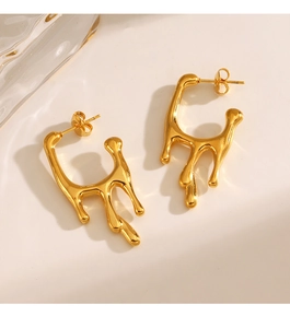 Detailed view of gold-tone geometric lava drop earrings with a metallic molten design