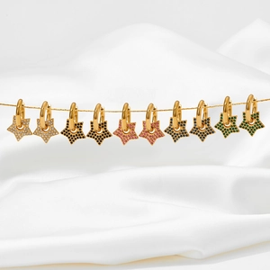 Detail view of multi-color star-shaped hoop earrings on elegant silk fabric background