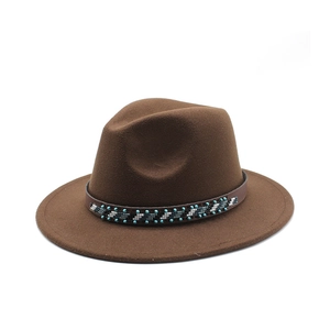 Detail of brown wool fedora hat with ethnic style beaded band on white background