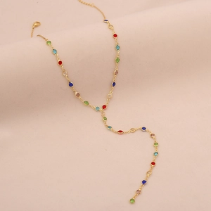 Close-up of golden Y-shaped necklace with vibrant multicolored round crystal gemstones