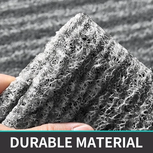 Close-up of durable PVC coil mat showing mesh structure and flexibility in grey