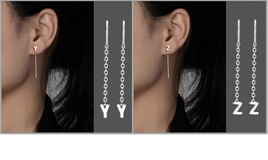 Close-up of S999 silver ear threads with Y and Z letter charms on dark background