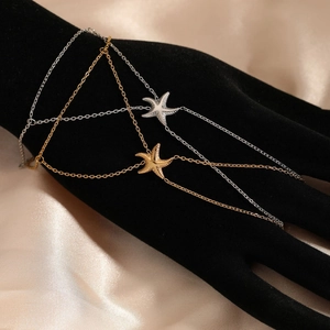Chic starfish finger bracelet in gold and silver finish for beach style elegance