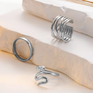 Detailed view of silver titanium steel rings set with snake and hollow star moon designs