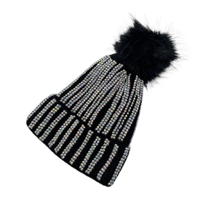 Macro view of black knitted beanie featuring colorful rhinestones and fluffy pom-pom top