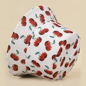 Detail of cherry pattern bucket hat showing high-quality stitching and cotton fabric