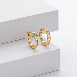 Macro shot of gold-plated S925 silver hoop earrings with shimmering white zircon stones