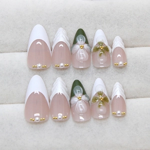 French almond press-on nails with 3D floral accents and gold beads in white and green