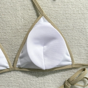 Detailed close-up of white bikini cup interior with beige stitching and soft inner lining