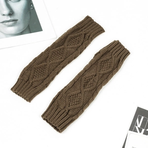 Close-up of coffee brown cable knit arm warmers with soft wool texture in a flat lay style