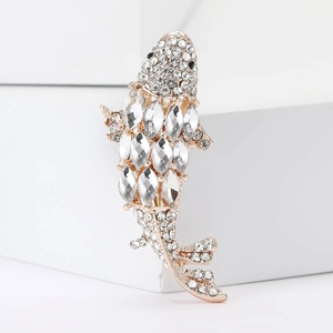 Detail of rose gold fish brooch featuring marquise and round cut sparkling crystals