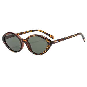 Retro tortoise cat-eye sunglasses with dark green lenses and silver dot temple accents