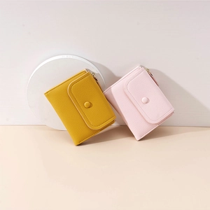 Short bifold wallets in yellow and pink PU leather with snap closure and coin pocket