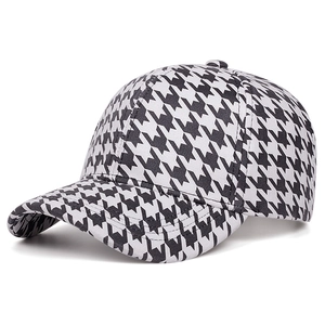 Side view of black and white houndstooth baseball cap showing high-quality stitching