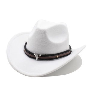Close-up of a white felt cowboy hat featuring a metal bull head emblem and braided band