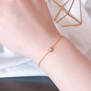 Minimalist gold titanium steel bracelet with a single round crystal on a delicate chain
