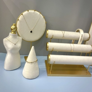 Premium velvet jewelry display set with gold necklaces and pearl bracelets on white stands