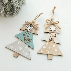 Christmas tree shaped wooden ornaments with Joyeux Noel text and snowflake decor