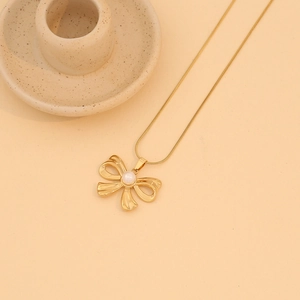 Golden bow necklace with pearl pendant on a sleek snake chain for women stylish jewelry