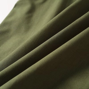 Macro view of army green cotton linen fabric texture and detailed plain weave pattern