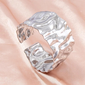 Polished silver stainless steel cuff bangle with hammered texture on pink silk