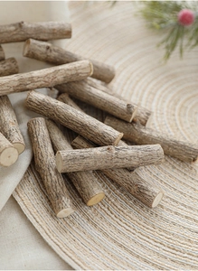 Detail of natural wood sticks on woven mat for DIY crafts and Christmas decor