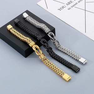 Detailed view of woven titanium steel bracelets in gold, black, and silver with metal knots