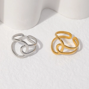 Close-up of twisted geometric open rings in polished gold and silver finishes
