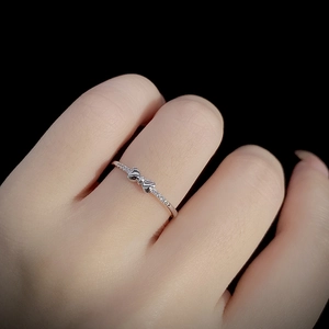 Elegant S925 sterling silver bow ring with sparkling pavé crystals worn on a hand