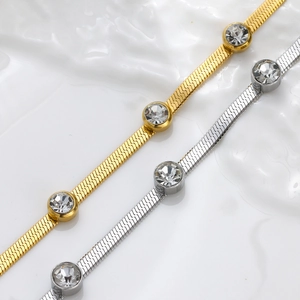 Detail of gold and silver herringbone chains with bezel-set cubic zirconia accents