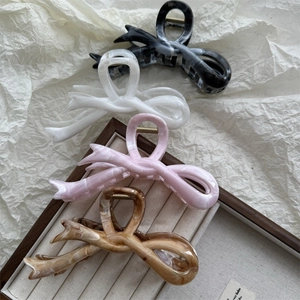 Selection of large bow hair claws in marble black, white, pink and brown finishes