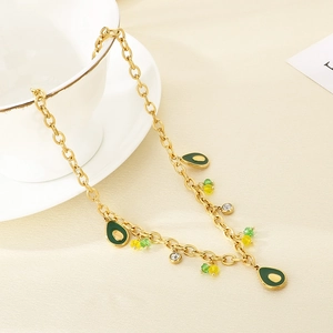 Detail of gold chain necklace with green avocado pendants and colorful beads