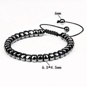 Macro detail of braided hematite bracelet with 6.5x4.5mm drum beads and adjustable drawstring