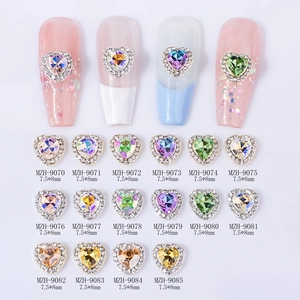 Macro detail of multi-color 7.5x8mm faceted heart nail art rhinestones in 16 shades