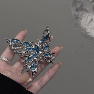 Silver liquid metal butterfly hair claw clip with blue gems for women's hair styling