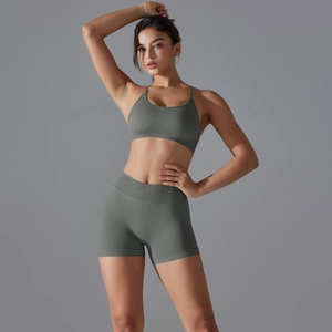 Detail of sage green seamless high-waist yoga shorts and strappy sports bra set